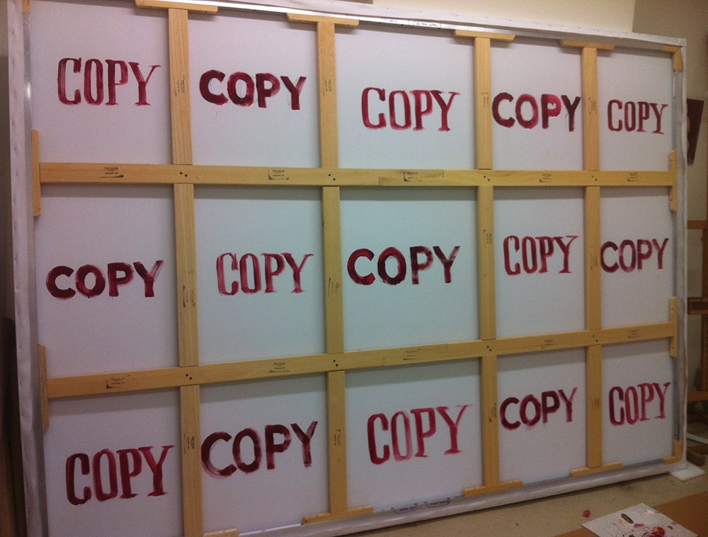 Photo of the back of a canvas that says "COPY".